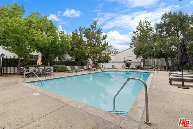 a view of outdoor space with swimming pool and sitting area