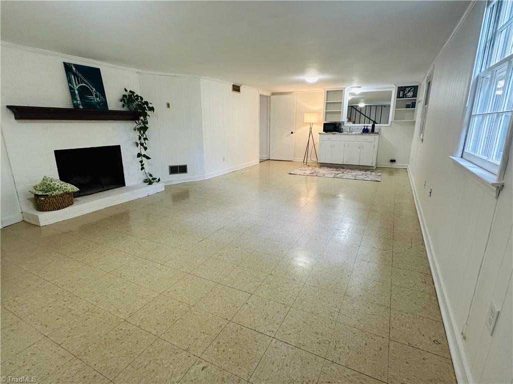 4261 Witherow Road Winston-Salem, NC 27106 - Photo 26 of 40 Basement recreation room with fireplace and kitchenette.