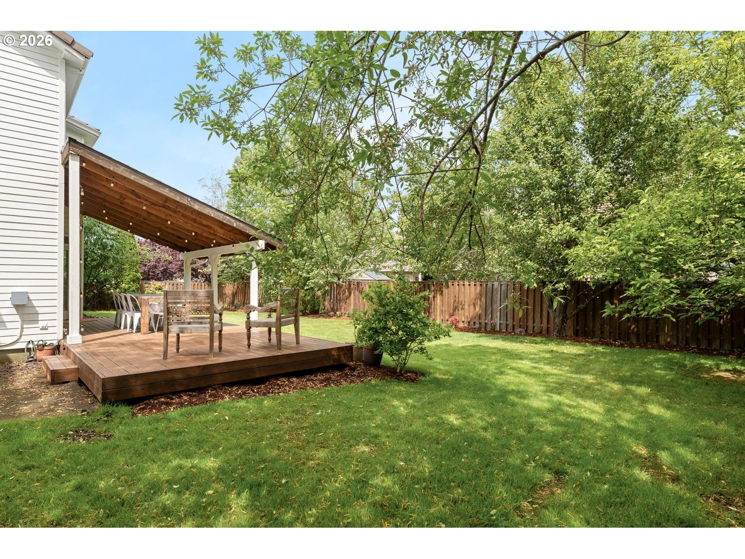 2519 Northwest 24th Circle Camas, WA 98607 - Photo 46 of 48 a view of a backyard with table and chairs and potted plants