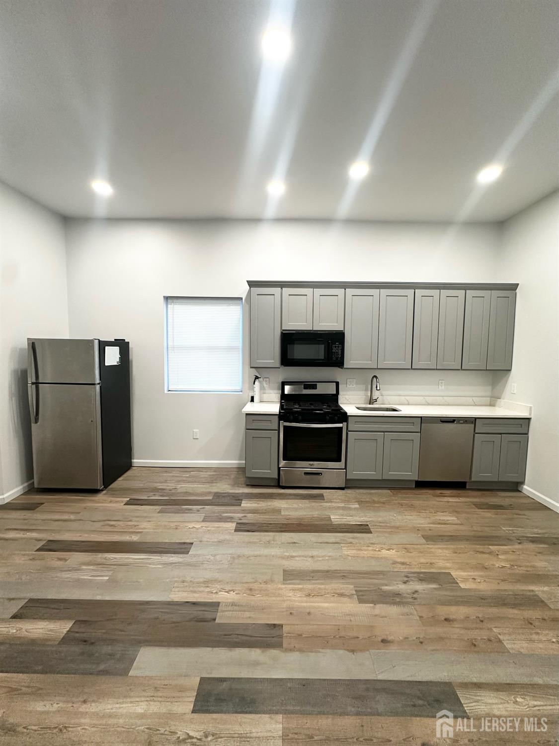 a view of kitchen with stainless steel appliances kitchen island