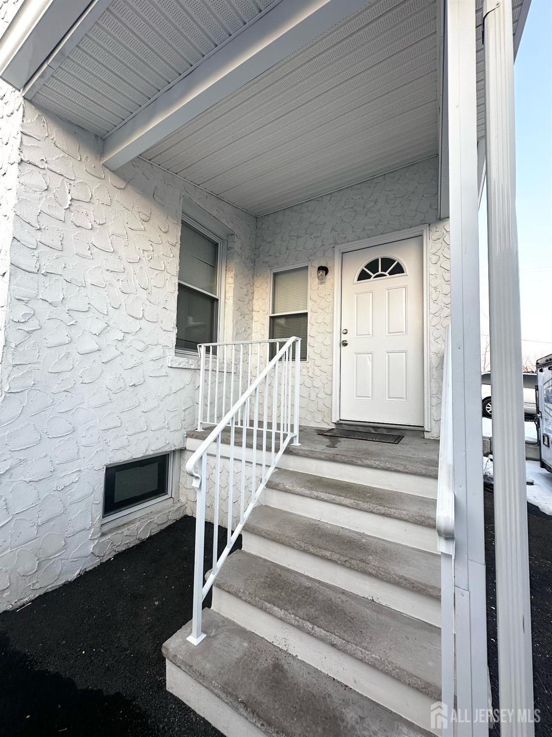 55 Cutters Dock Road, Unit B Woodbridge, NJ 07095 - Photo 2 of 13 a view of staircase with white walls and windows