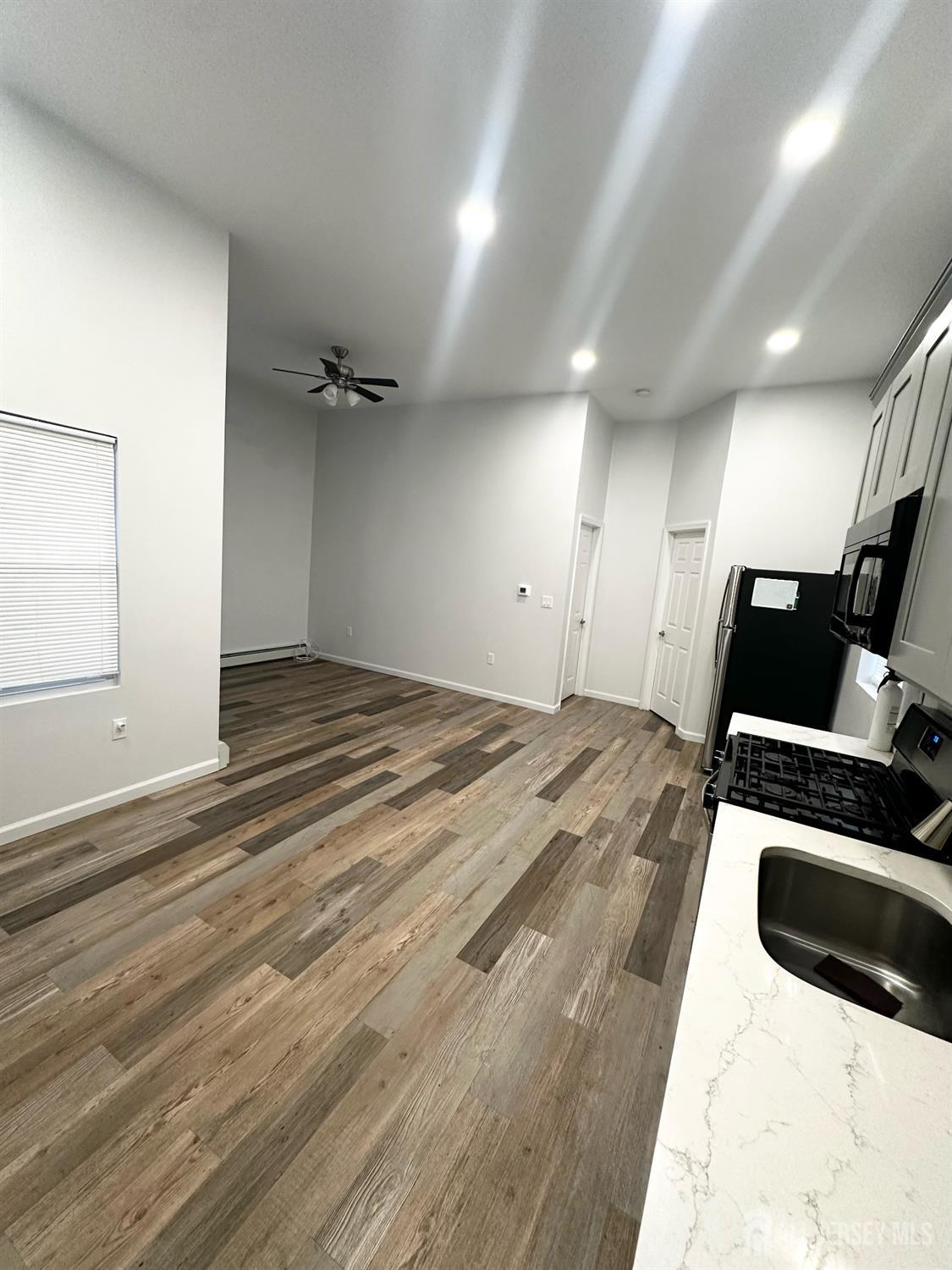 55 Cutters Dock Road, Unit B Woodbridge, NJ 07095 - Photo 6 of 13 a view of a livingroom with a flat screen tv