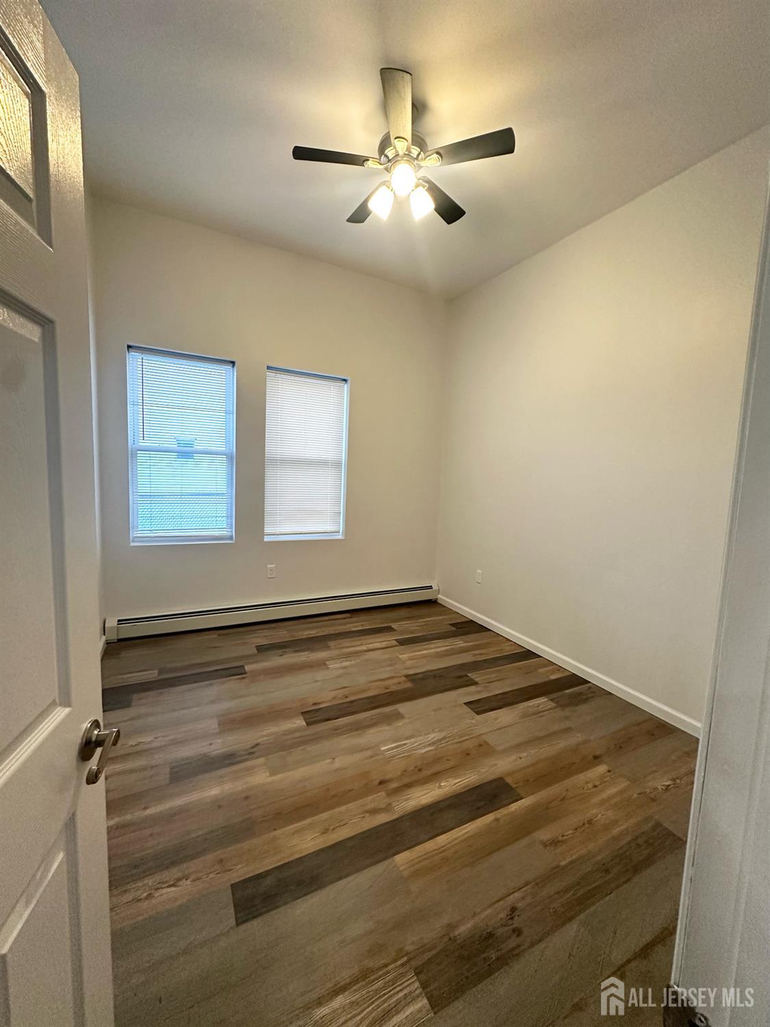 55 Cutters Dock Road, Unit B Woodbridge, NJ 07095 - Photo 8 of 13 a view of a livingroom and a ceiling fan