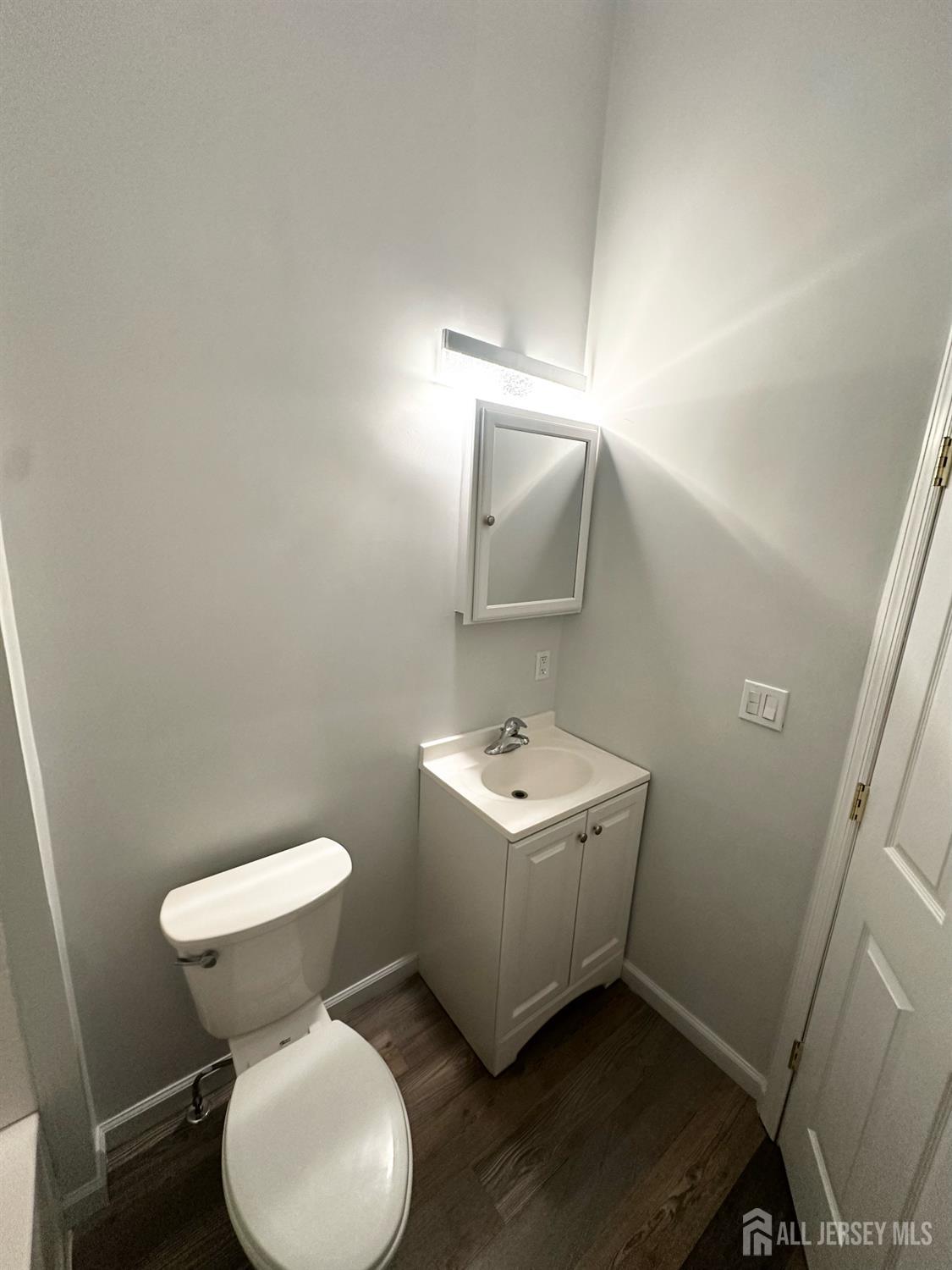 55 Cutters Dock Road, Unit B Woodbridge, NJ 07095 - Photo 10 of 13 a bathroom with sink toilet and mirror