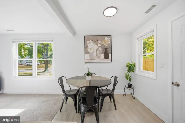 a dining room with furniture and window