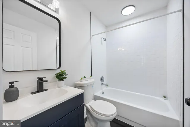 a bathroom with a sink toilet vanity and shower