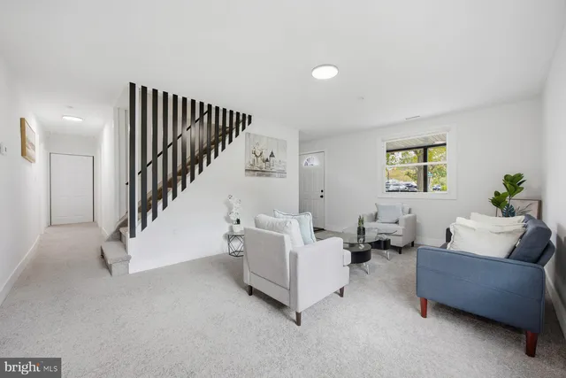 a living room with furniture and stairs