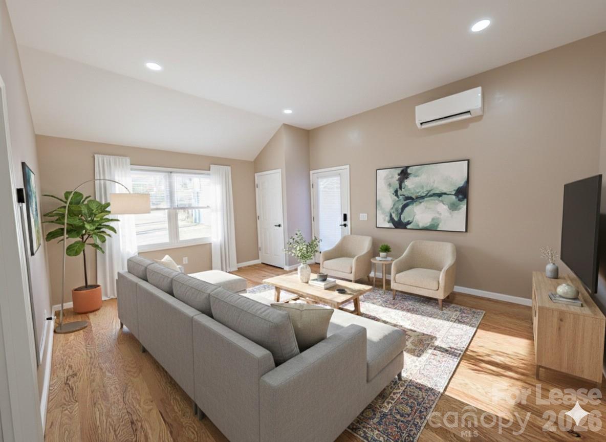 3211 Winding Trail, Unit 2 Matthews, NC 28105 - Photo 1 of 10 a living room with furniture and a flat screen tv
