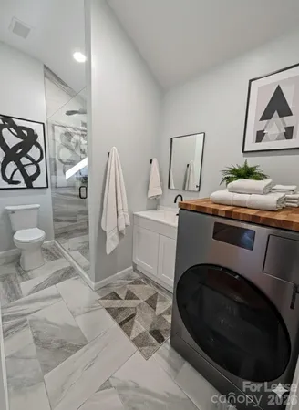 a utility room with sink dryer and washer