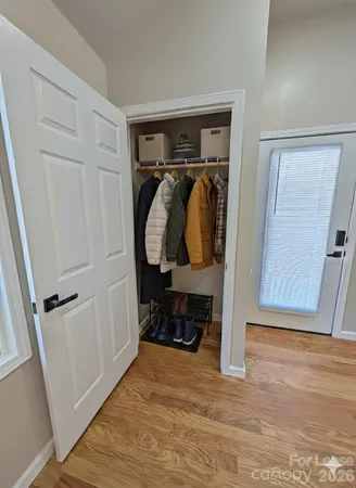 a view of walk in closet with clothes and shoes
