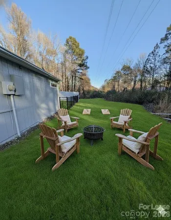 a backyard of a house with table and chairs