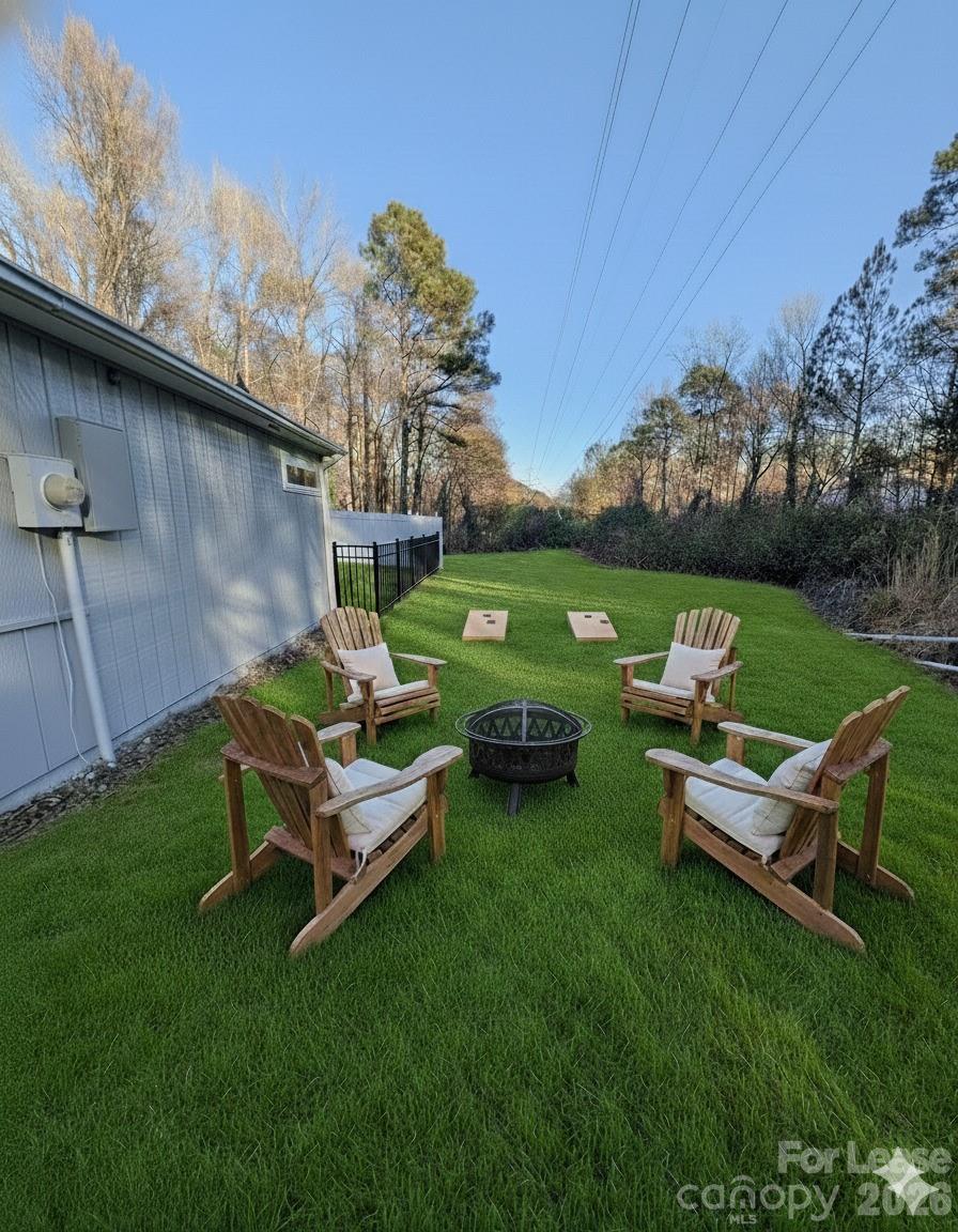 3211 Winding Trail, Unit 2 Matthews, NC 28105 - Photo 8 of 10 a backyard of a house with table and chairs
