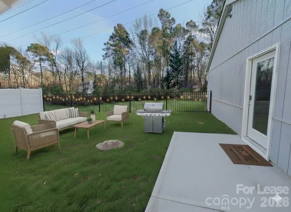 a view of a garden with couches and a table