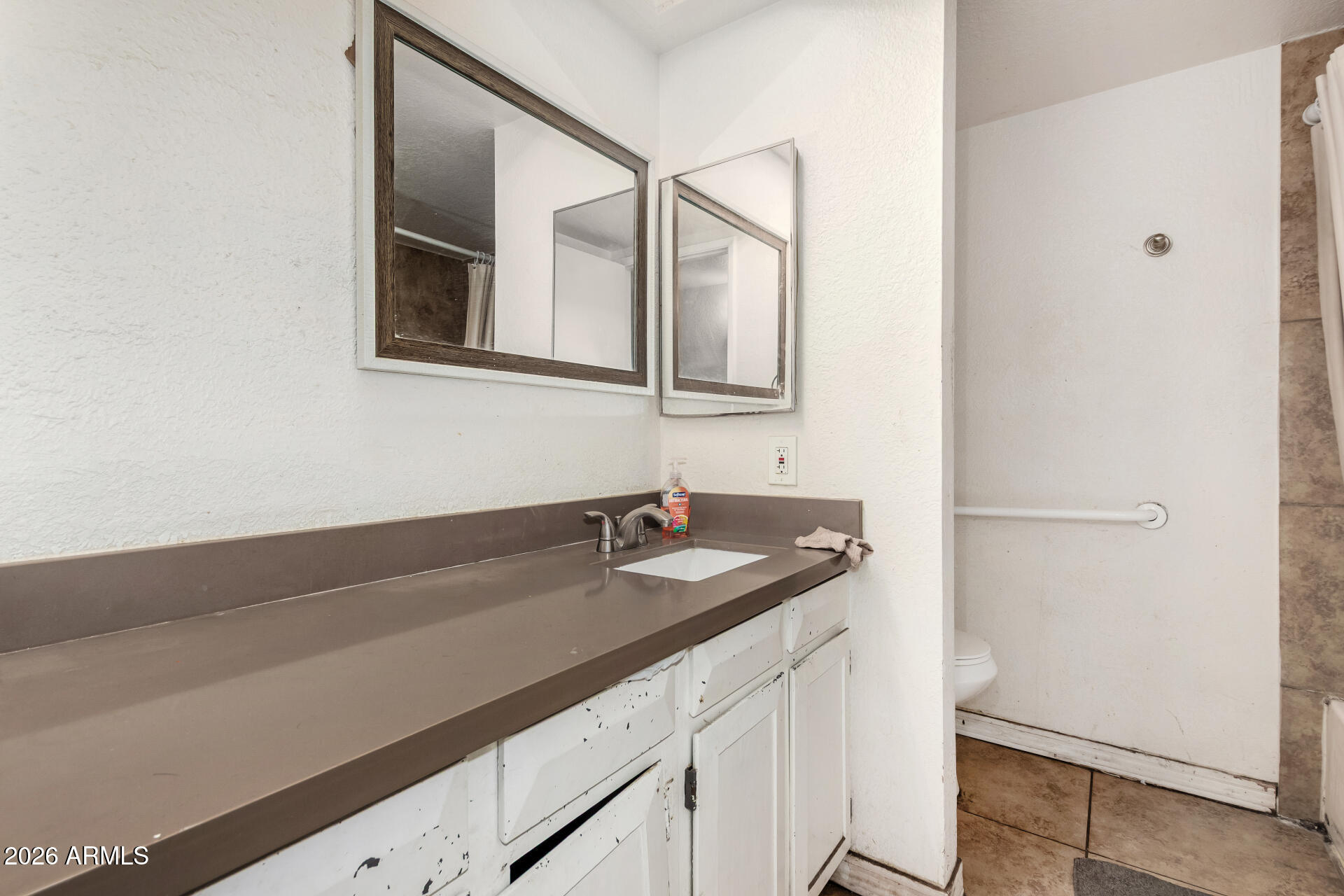 7522 West Cheery Lynn Road Phoenix, AZ 85033 - Photo 11 of 14 a bathroom with a sink and a mirror
