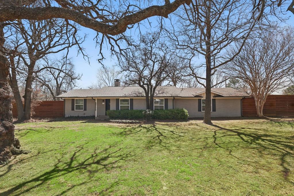 a front view of house with yard and trees