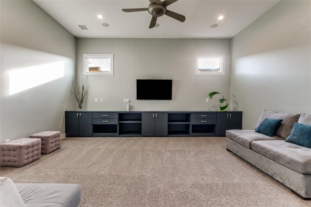7912 Hanover Street Dallas, TX 75225 - Photo 19 of 29 Spacious playroom featuring a built-in media console with storage, recessed lighting, and ceiling fan