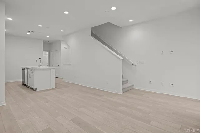 a view of a big room with closet and windows