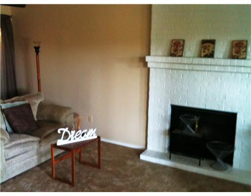 7122 Premont Drive, Unit C104 Corpus Christi, TX 78414 - Photo 2 of 9 a living room with furniture and a fireplace