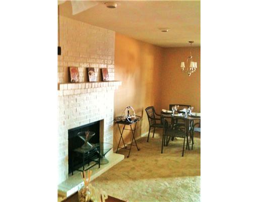 7122 Premont Drive, Unit C104 Corpus Christi, TX 78414 - Photo 3 of 9 a living room with furniture and a fireplace