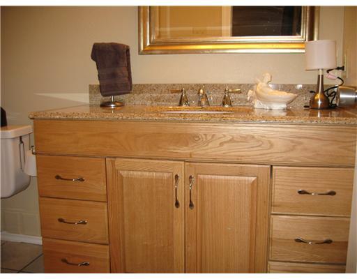 7122 Premont Drive, Unit C104 Corpus Christi, TX 78414 - Photo 6 of 9 a bathroom with a sink and a mirror