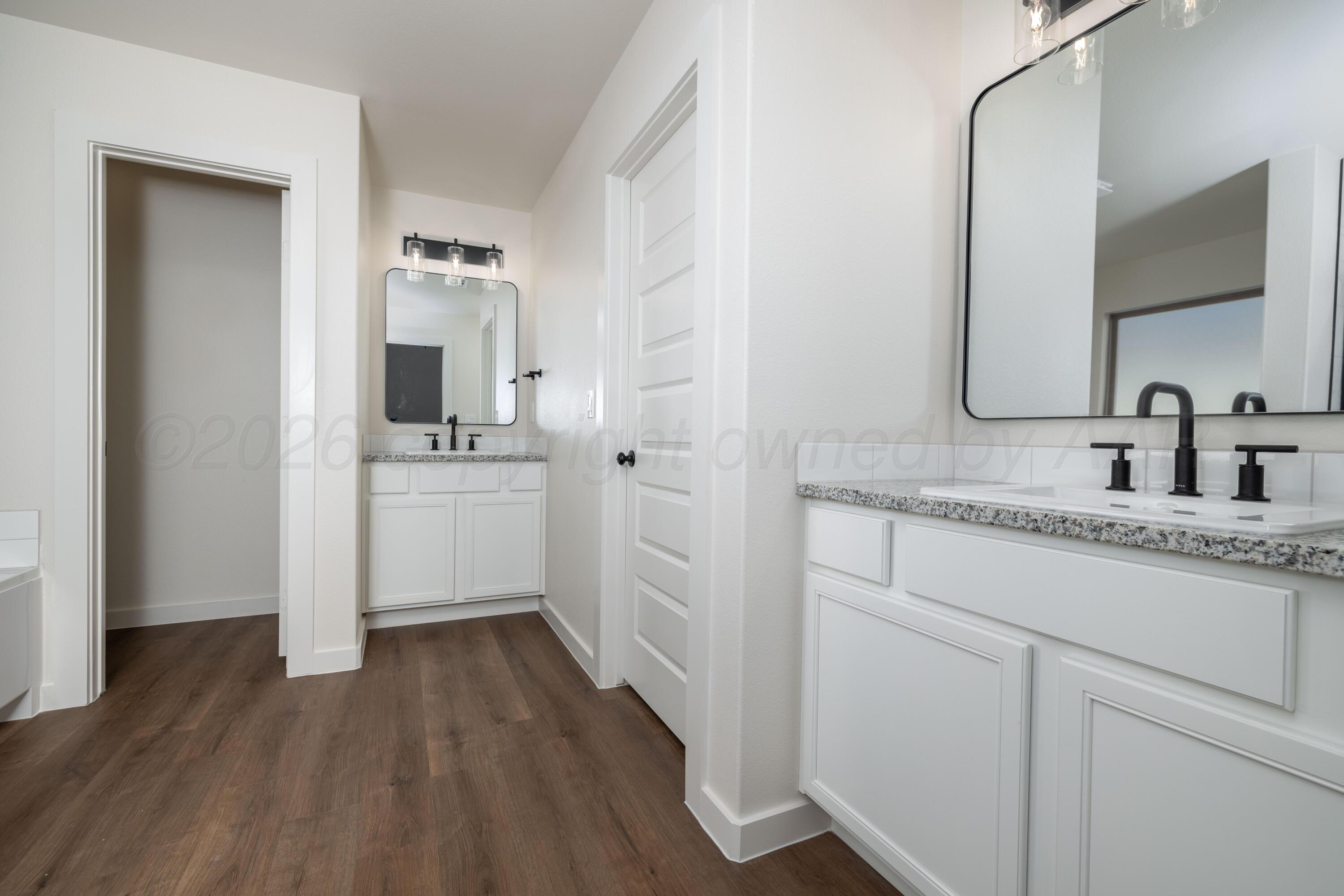 3000 Flycatcher Road Amarillo, TX 79124 - Photo 8 of 11 a bathroom with a sink and a mirror