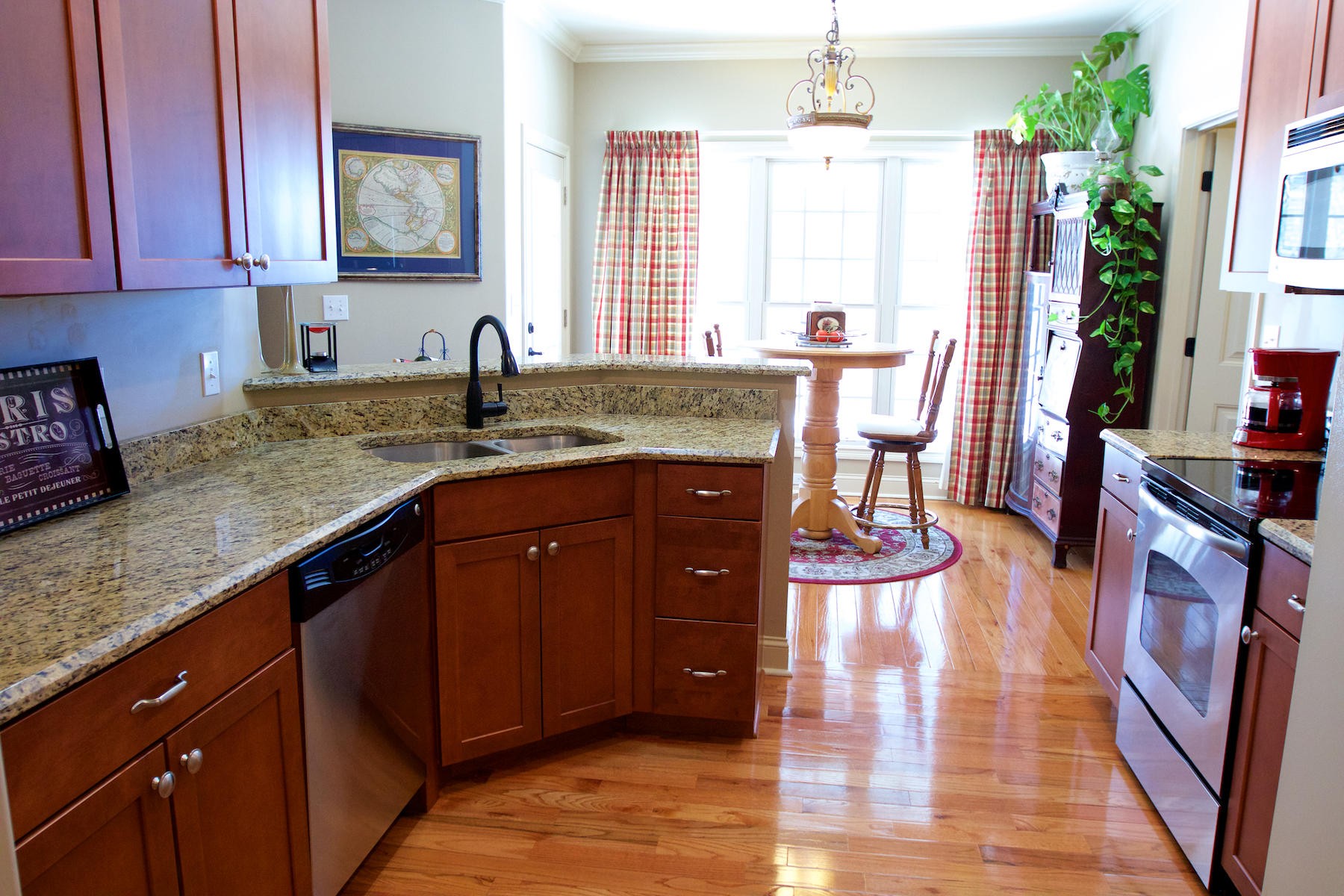 113 Crossroads Boulevard Oak Ridge, TN 37830 - Photo 10 of 24 a kitchen with stainless steel appliances granite countertop a sink dishwasher stove and wooden cabinets