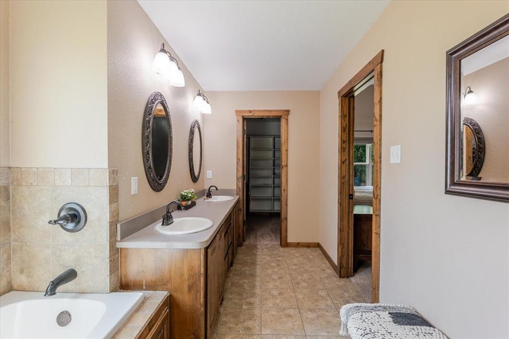181 Savannah Drive Weatherford, TX 76087 - Photo 12 of 36 a bathroom with a sink a toilet and a mirror
