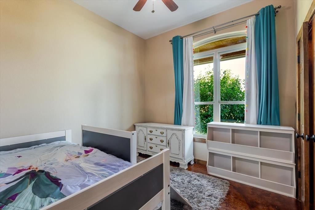 181 Savannah Drive Weatherford, TX 76087 - Photo 13 of 36 a bedroom with a bed and a window