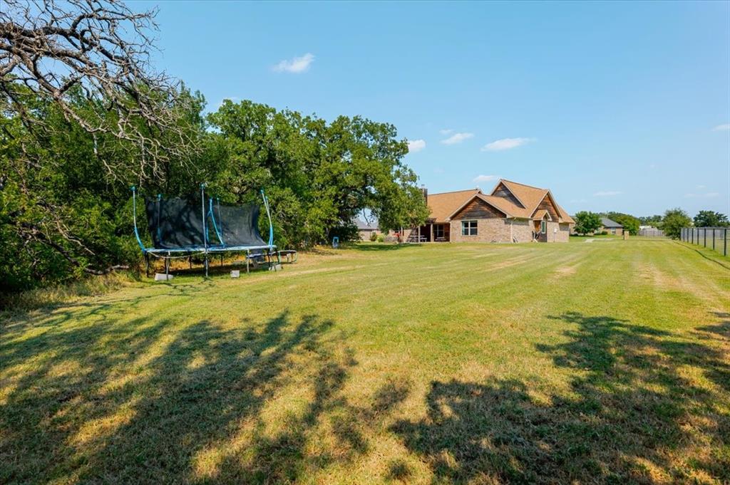 181 Savannah Drive Weatherford, TX 76087 - Photo 29 of 36 a view of a swimming pool with an outdoor space and seating area