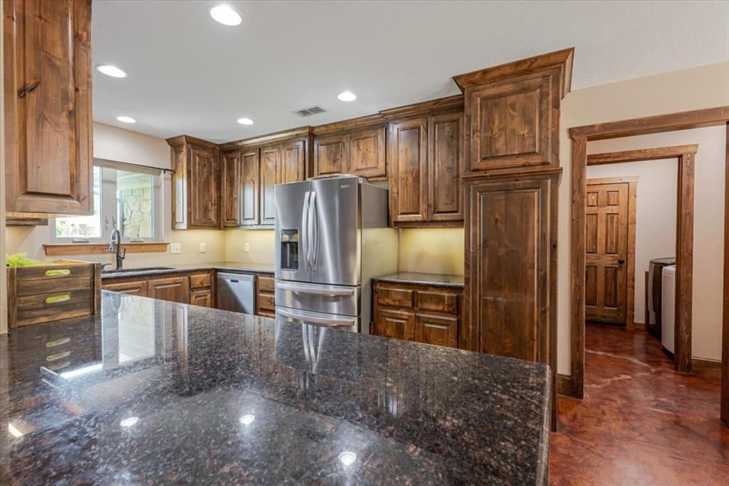 181 Savannah Drive Weatherford, TX 76087 - Photo 8 of 36 a kitchen with stainless steel appliances a refrigerator and a stove top oven