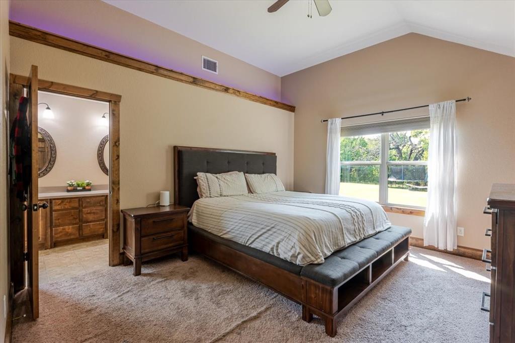 181 Savannah Drive Weatherford, TX 76087 - Photo 10 of 36 a bed sitting in a room next to a window