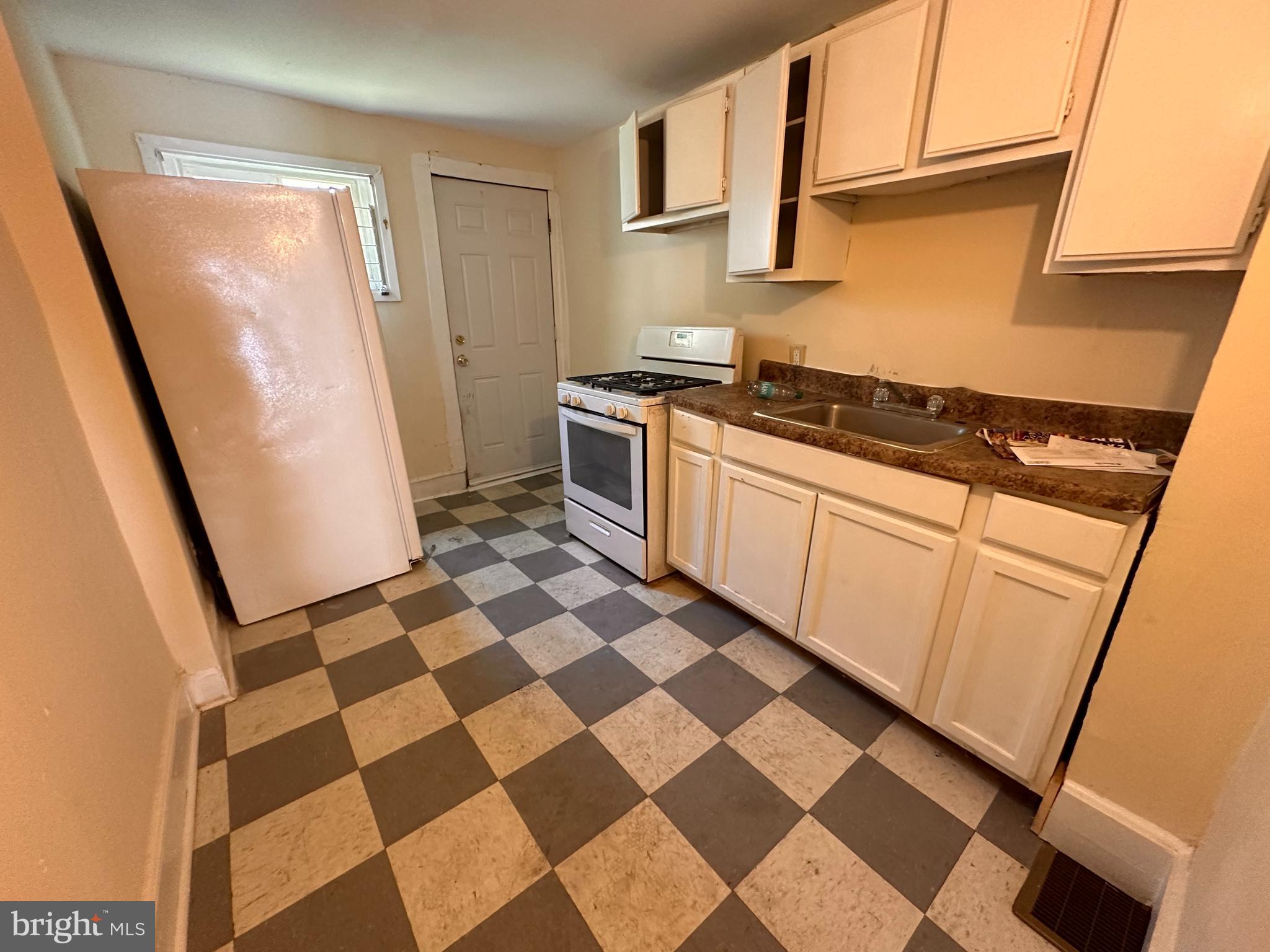 1904 Brunner Street Philadelphia, PA 19140 - Photo 5 of 10 a kitchen with a checkered floor and a stove top oven
