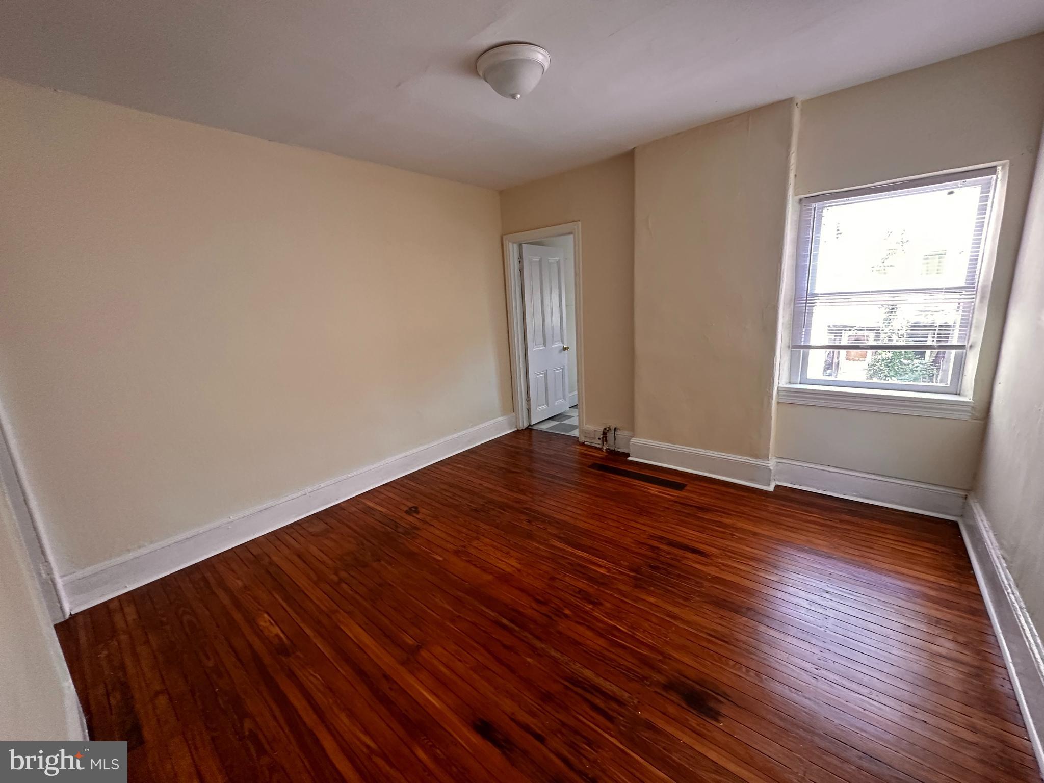 1904 Brunner Street Philadelphia, PA 19140 - Photo 9 of 10 an empty room with wooden floor and windows