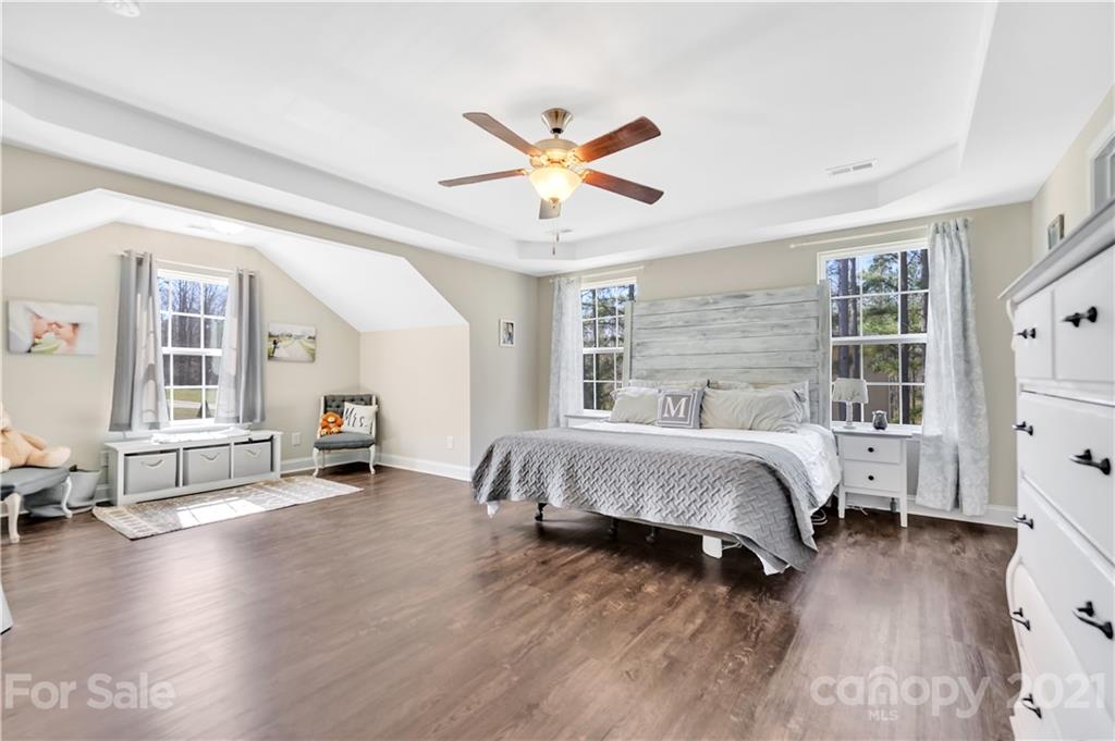 4081 Ruston Creek Road Catawba, SC 29704 - Photo 14 of 38 a spacious bedroom with a bed and wooden floor