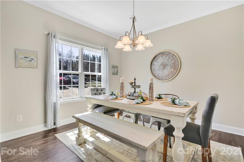 4081 Ruston Creek Road Catawba, SC 29704 - Photo 3 of 38 a view of a dining room with furniture a chandelier and wooden floor