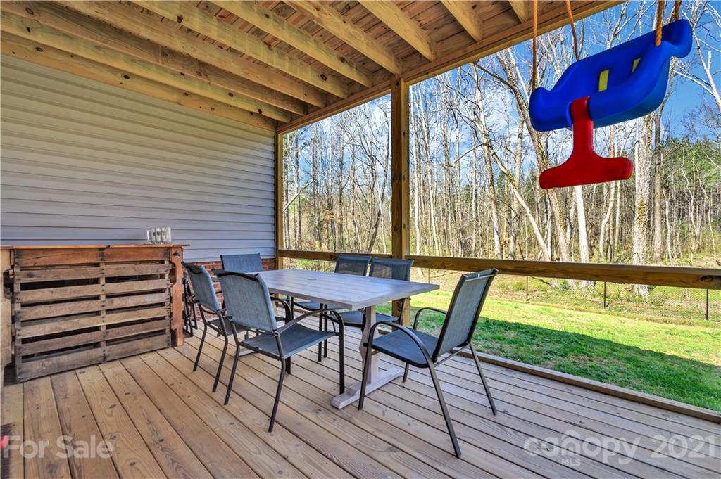 4081 Ruston Creek Road Catawba, SC 29704 - Photo 35 of 38 a view of a chairs and table in patio with wooden floor