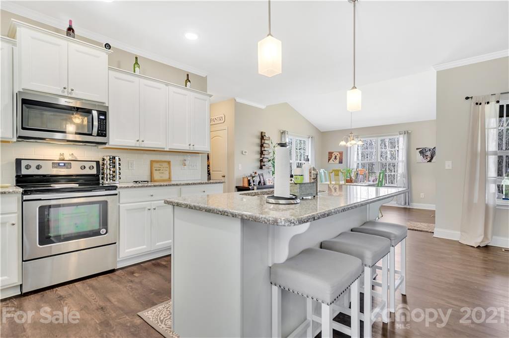 4081 Ruston Creek Road Catawba, SC 29704 - Photo 5 of 38 a kitchen with stainless steel appliances granite countertop a stove top oven a sink island and chairs