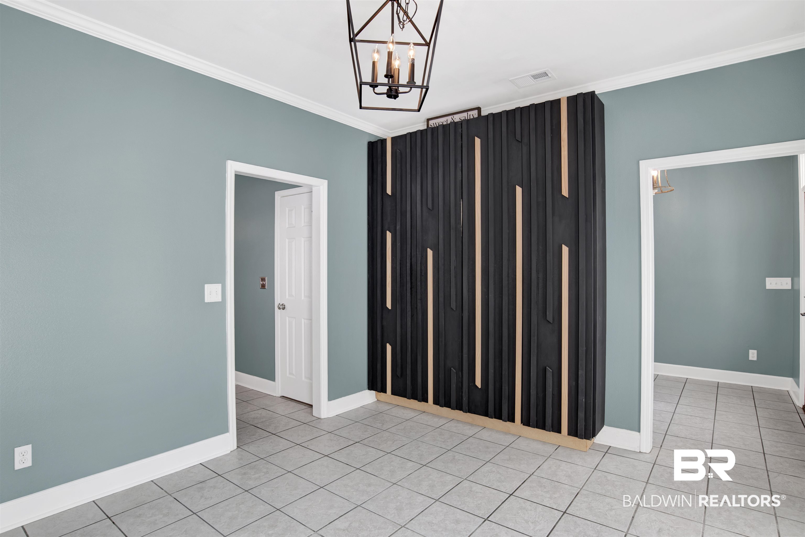 11835 Island Drive Foley, AL 36535 - Photo 40 of 53 Spare room featuring crown molding, a chandelier, and light tile patterned floors