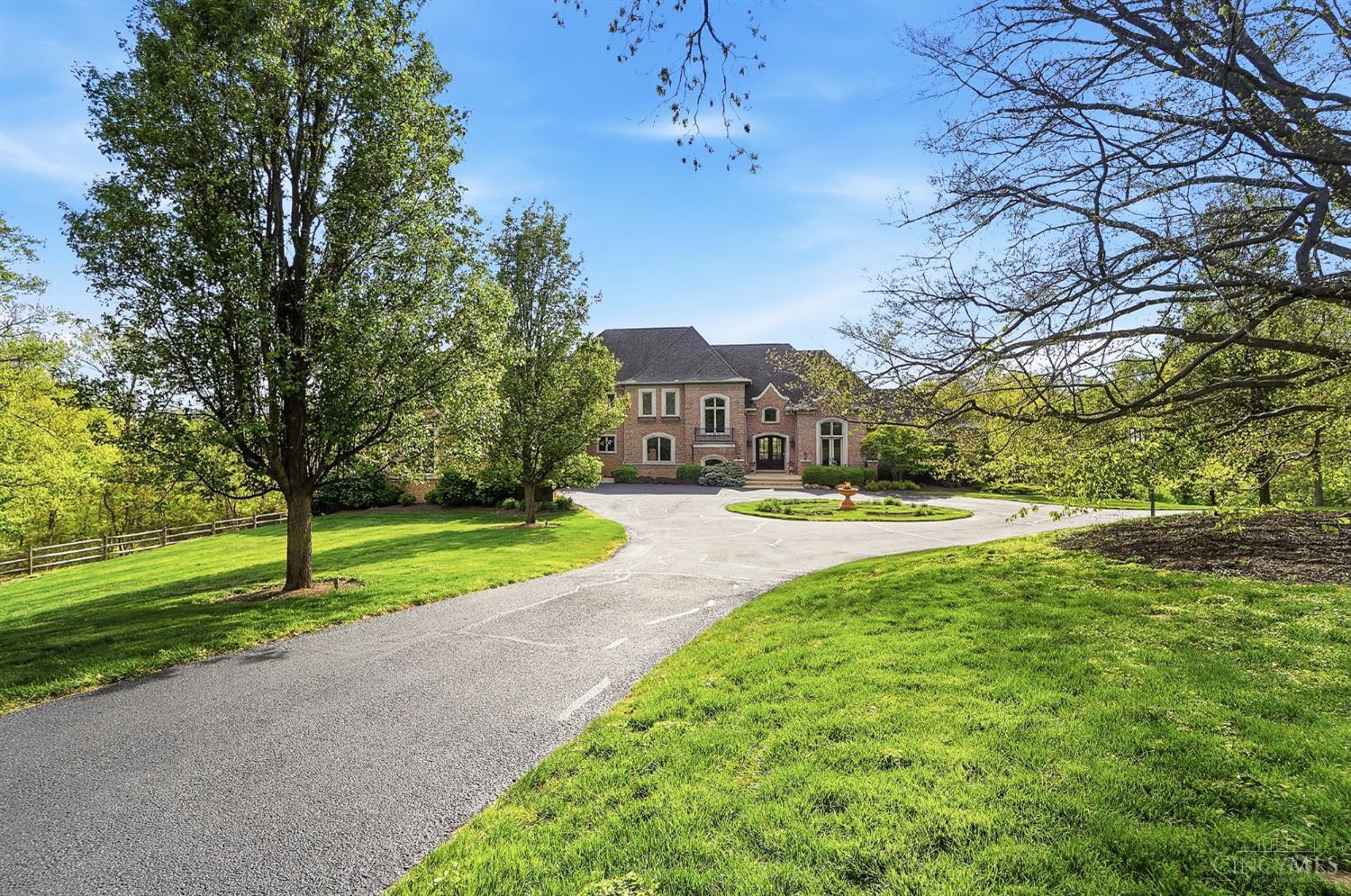 4535 Drake Road Cincinnati, OH 45243 - Photo 2 of 96 Built in 2009 by renowned builder Bernie Kurleman, this stunning residence seamlessly blends timeless architecture with luxurious modern updates, all while capturing breathtaking views of the Cincinnati skyline at night.