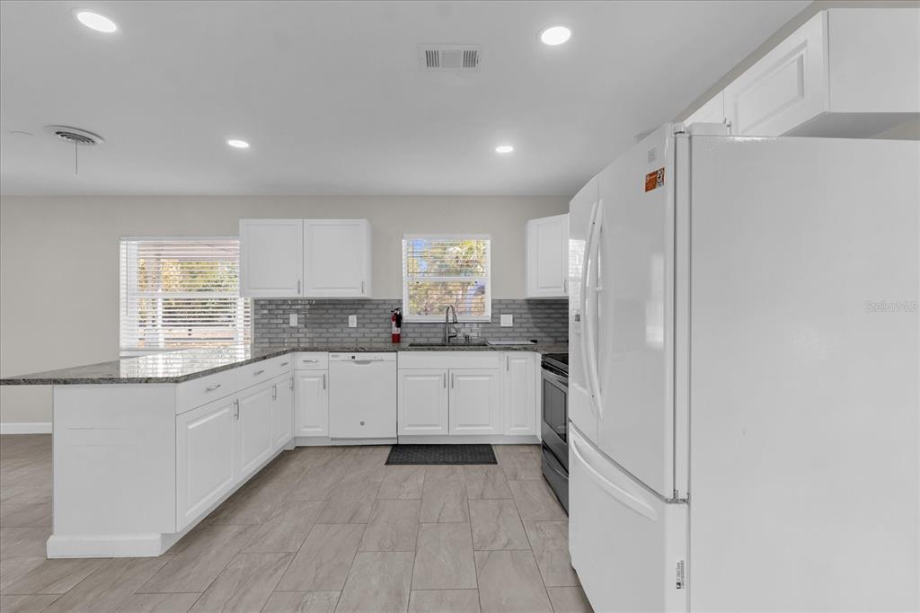 3800 Pine Street Cocoa, FL 32926 - Photo 12 of 31 a kitchen with white cabinets and white appliances
