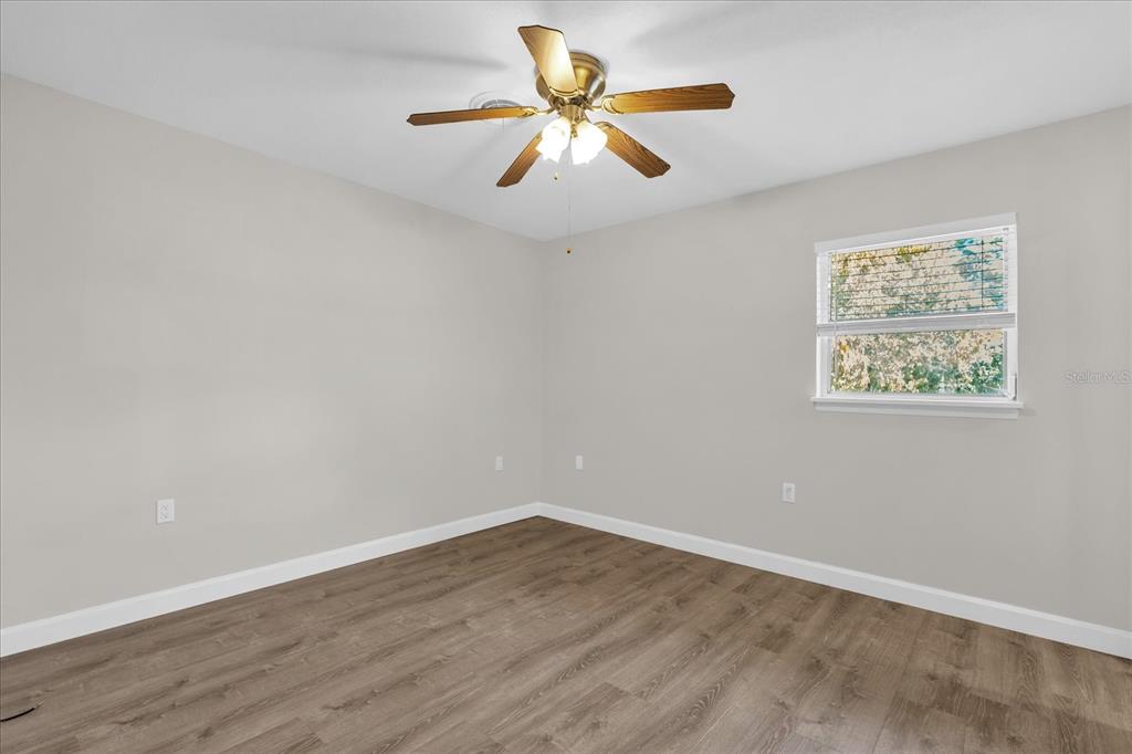 3800 Pine Street Cocoa, FL 32926 - Photo 15 of 31 a view of an empty room with window and wooden floor
