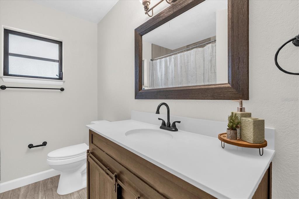 3800 Pine Street Cocoa, FL 32926 - Photo 20 of 31 a bathroom with a sink a toilet and mirror
