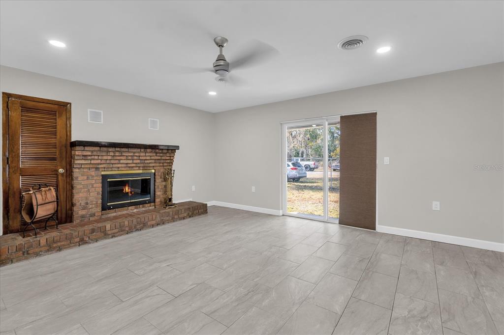 3800 Pine Street Cocoa, FL 32926 - Photo 6 of 31 an empty room with windows and fireplace