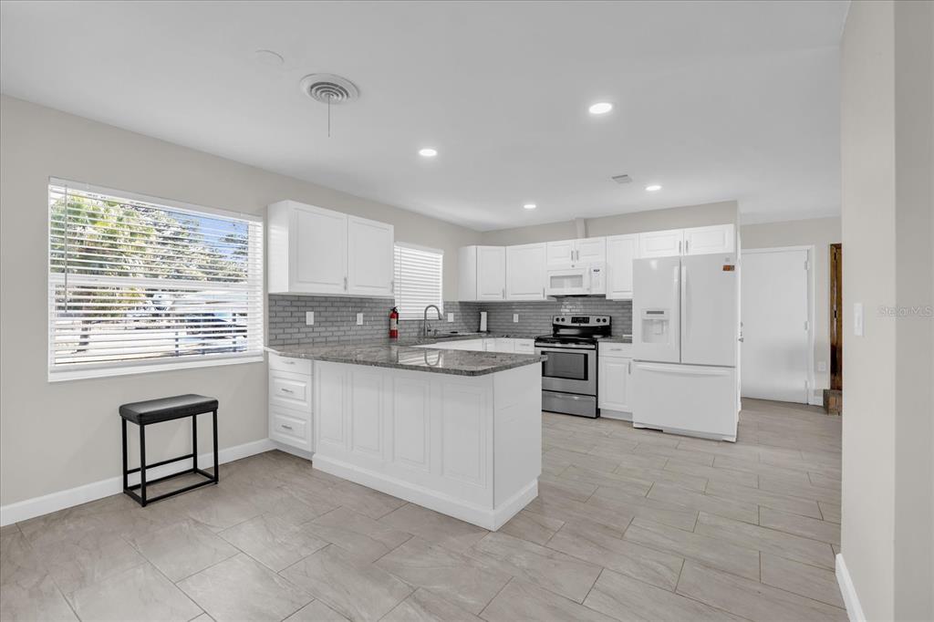 3800 Pine Street Cocoa, FL 32926 - Photo 9 of 31 a kitchen with cabinets and window
