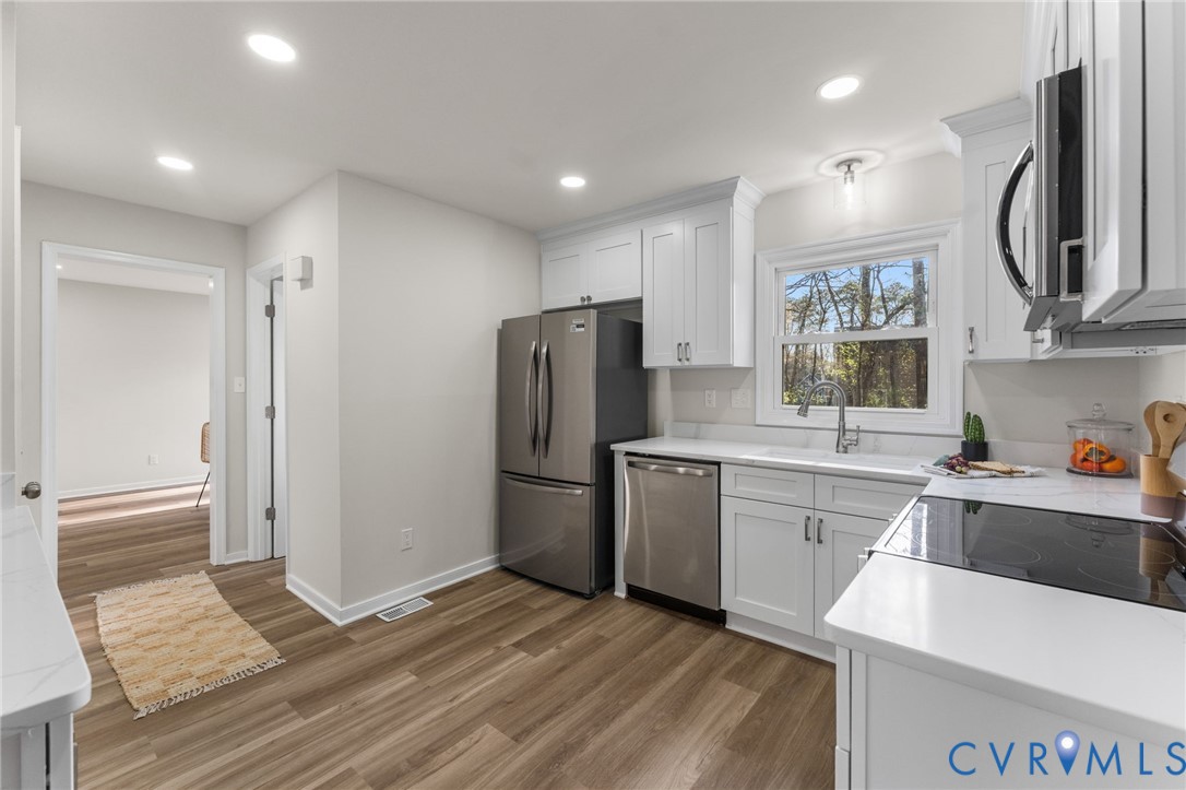10209 Stonemill Road Henrico, VA 23233 - Photo 11 of 28 a kitchen with a refrigerator sink and cabinets