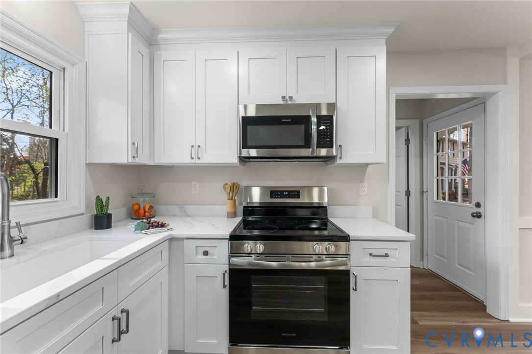 10209 Stonemill Road Henrico, VA 23233 - Photo 12 of 28 a kitchen with cabinets stainless steel appliances a sink and a stove