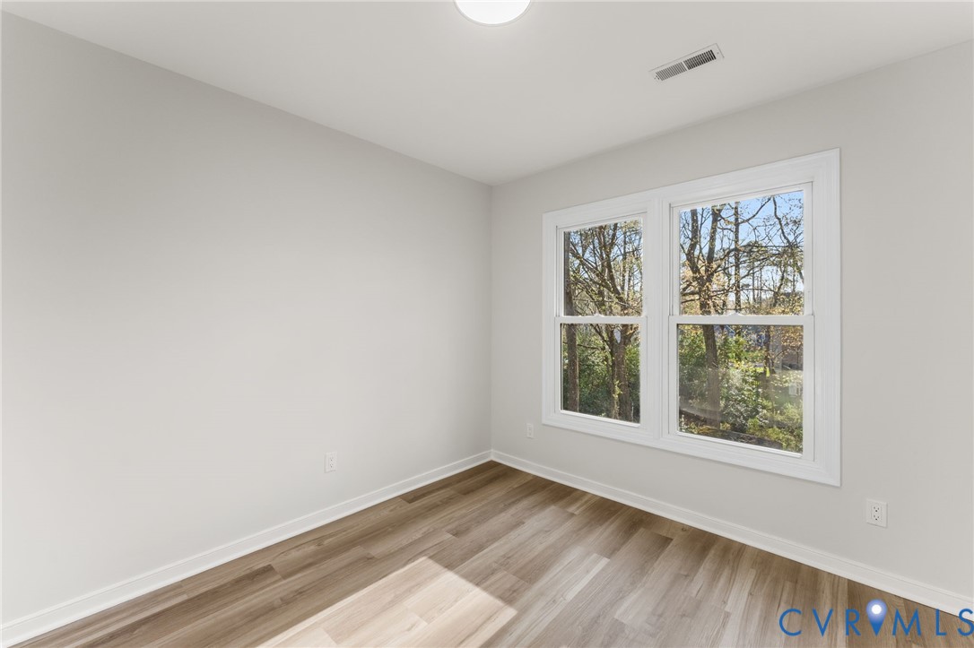 10209 Stonemill Road Henrico, VA 23233 - Photo 18 of 28 a view of an empty room with wooden floor and a window