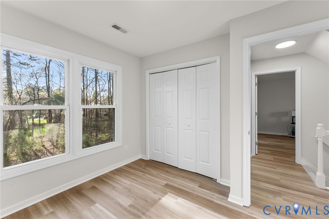 10209 Stonemill Road Henrico, VA 23233 - Photo 19 of 28 a view of an empty room with wooden floor and a window