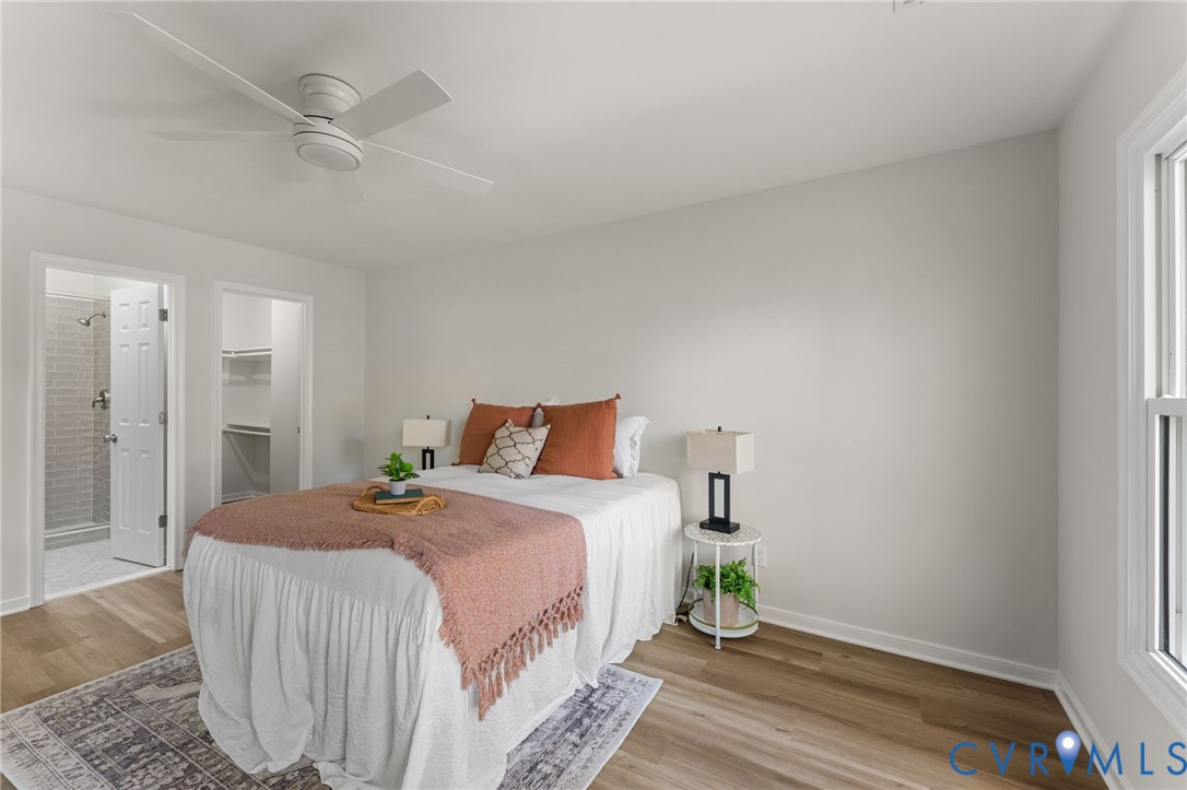 10209 Stonemill Road Henrico, VA 23233 - Photo 24 of 28 a bedroom with a bed and a chandelier