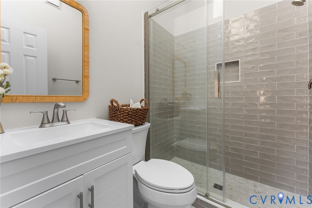 10209 Stonemill Road Henrico, VA 23233 - Photo 25 of 28 a bathroom with a sink a toilet and shower